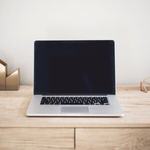 Macbook on desk with gold metal decorations