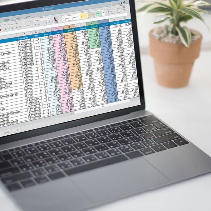 laptop open to financial Excel spreadsheet